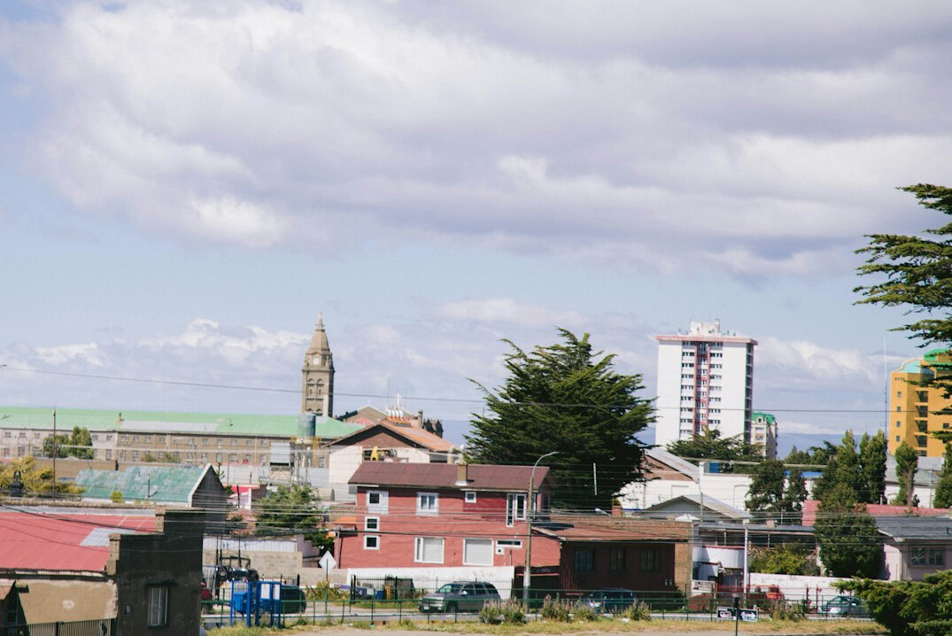 Street scene in a Chilean city with people walking past colorful houses