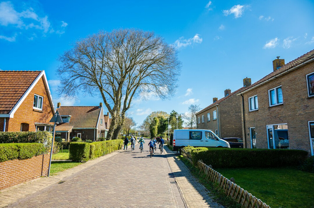Group of school children walking together down a residential street