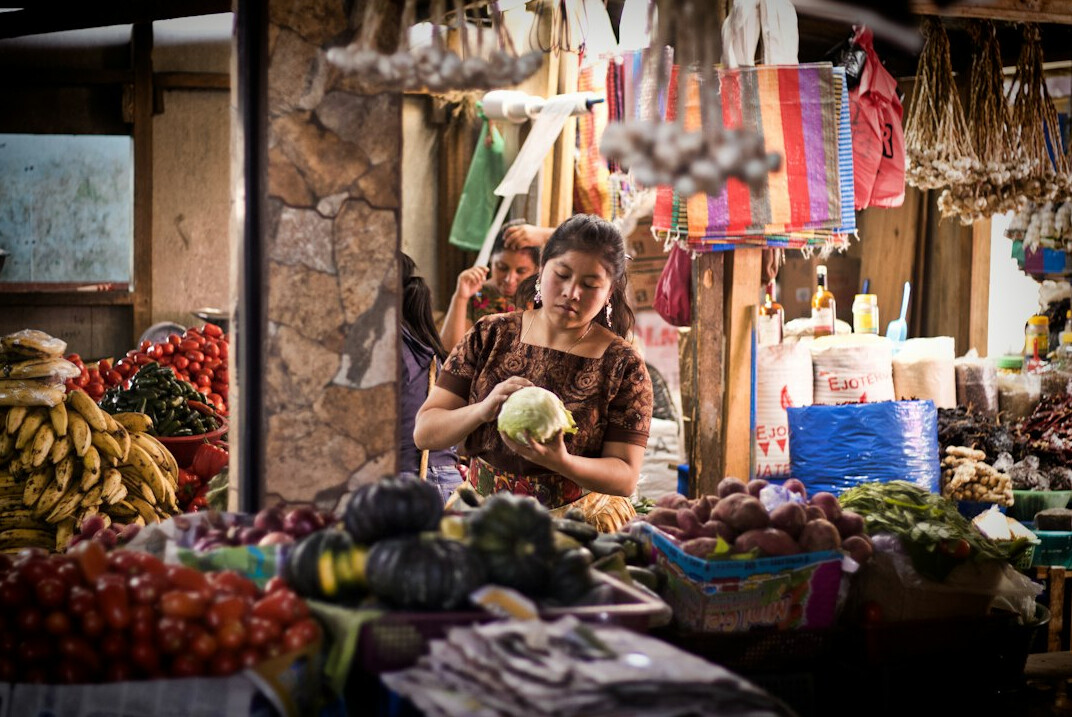 woman buying vegetables at market