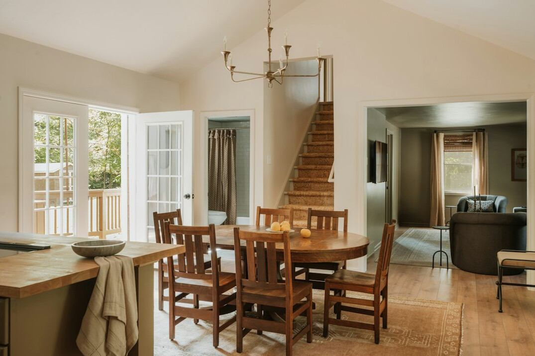Family gathered around a wooden kitchen table sharing a meal