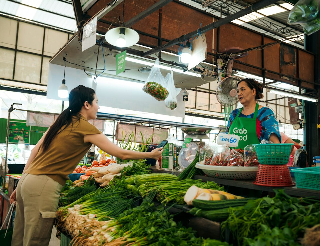 woman buying vegetables at market