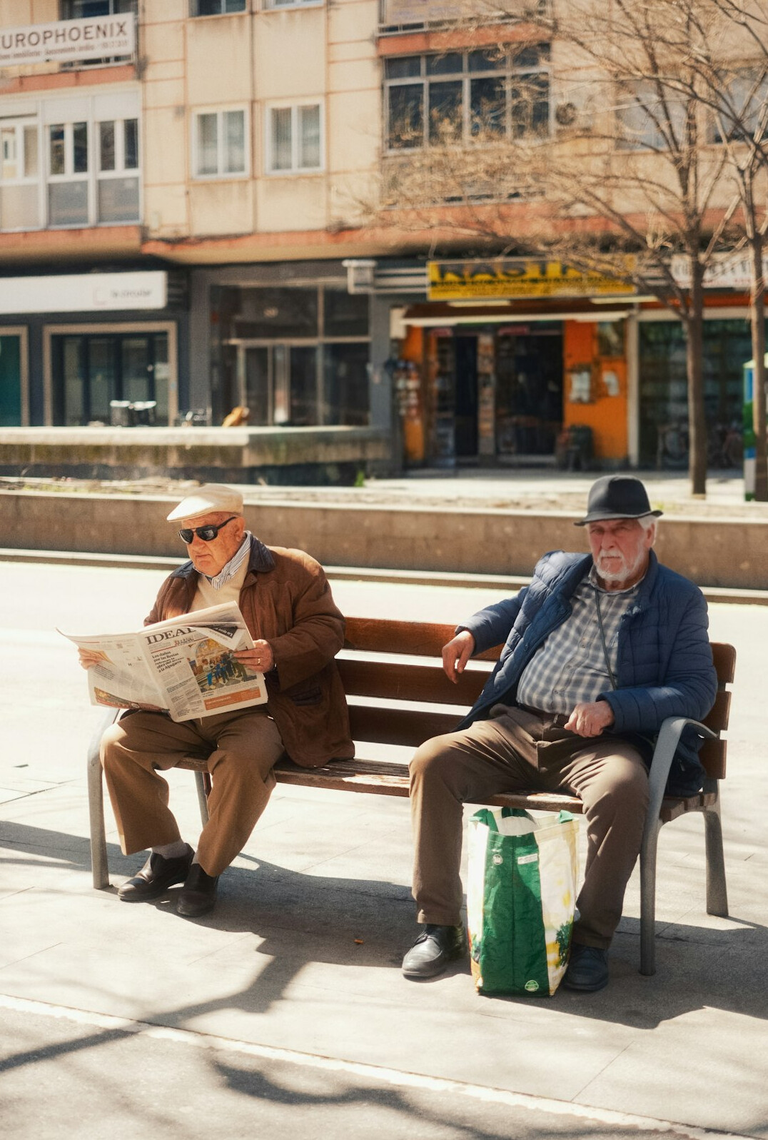 elderly man sitting on bench