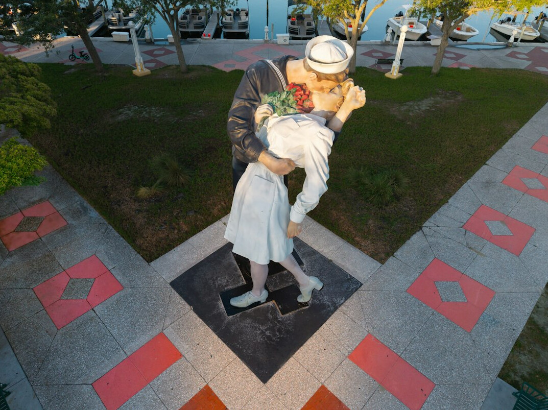 elderly couple walking in plaza